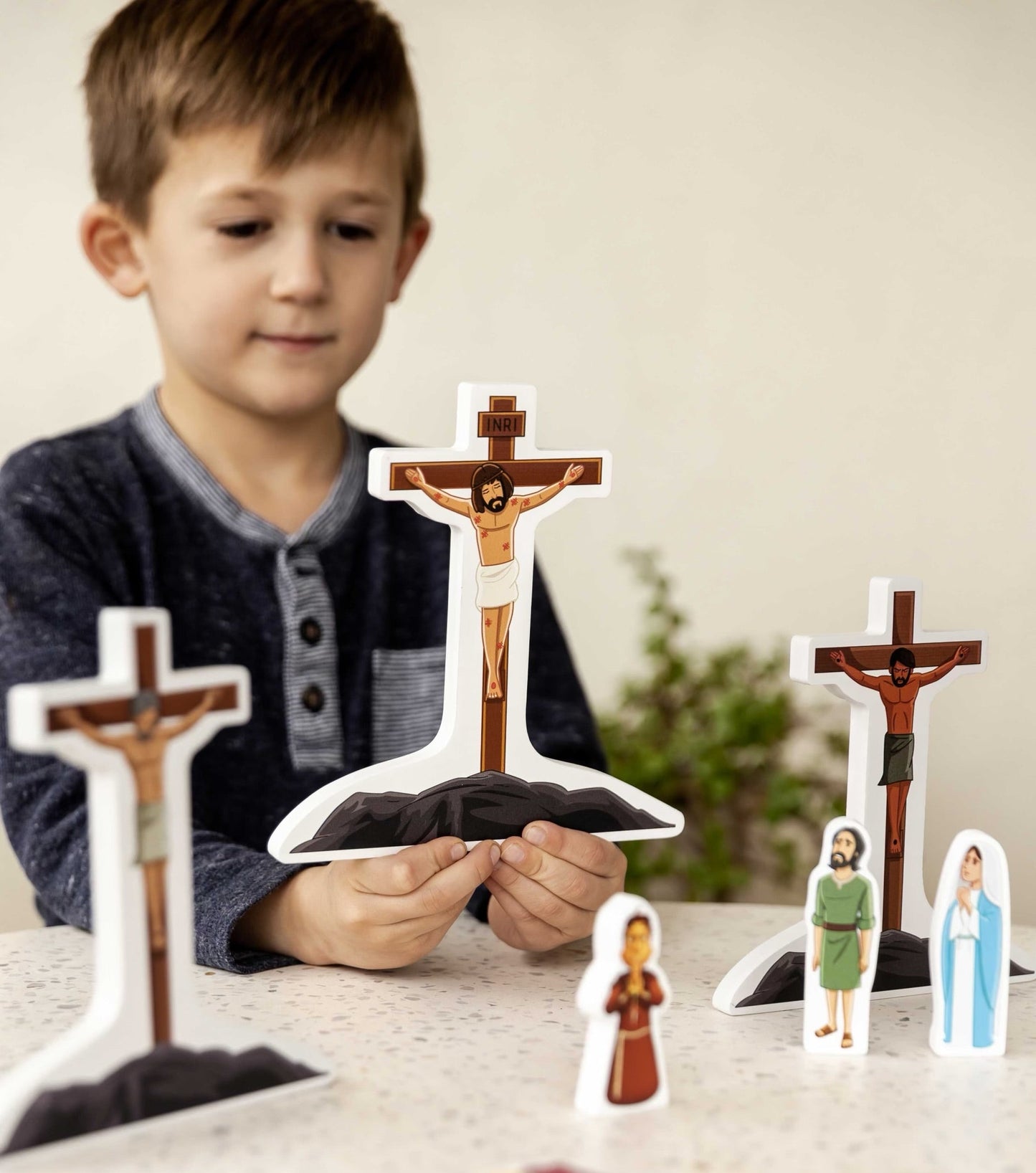 Child with Stations of the Cross play set. Religious toy for kids. Jesus and Cross. Saintly Heart and Brother Francis.