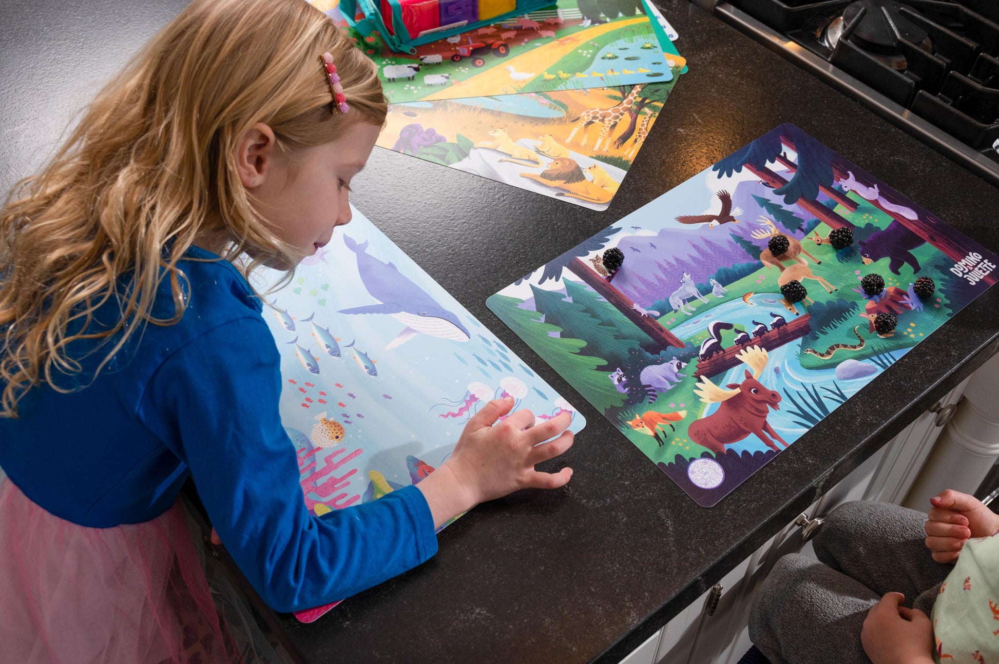Child playing with Puzzle Planet's "Farm Sea to Shining Sea" animal placemats.