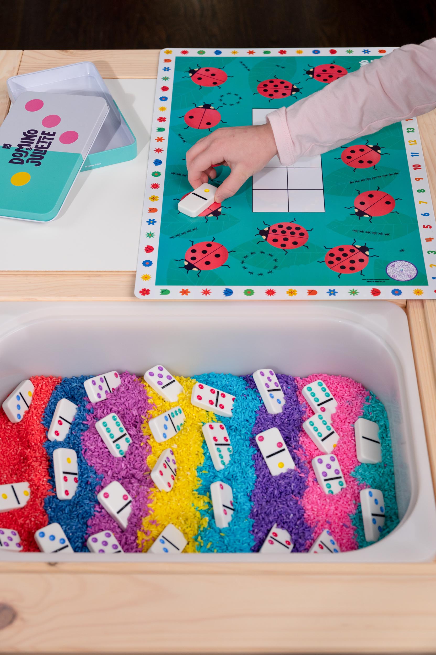 Dominoes sensory play for kids: Colorful tiles in rice bin. Domino Juliette set by Puzzle Planet for learning and fun!